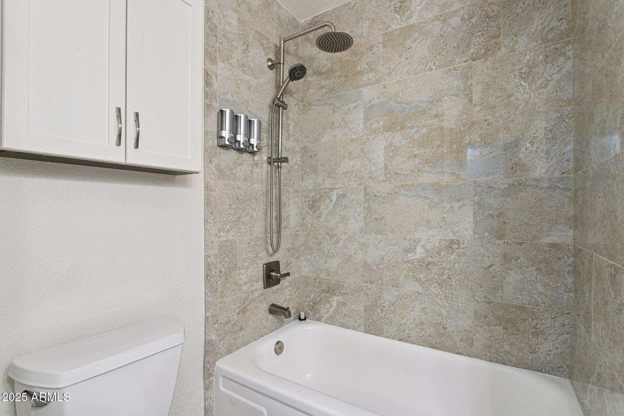 4915 East Everett Drive Scottsdale, AZ 85254 - Photo 30 of 39 a bathroom with a bathtub and a shower