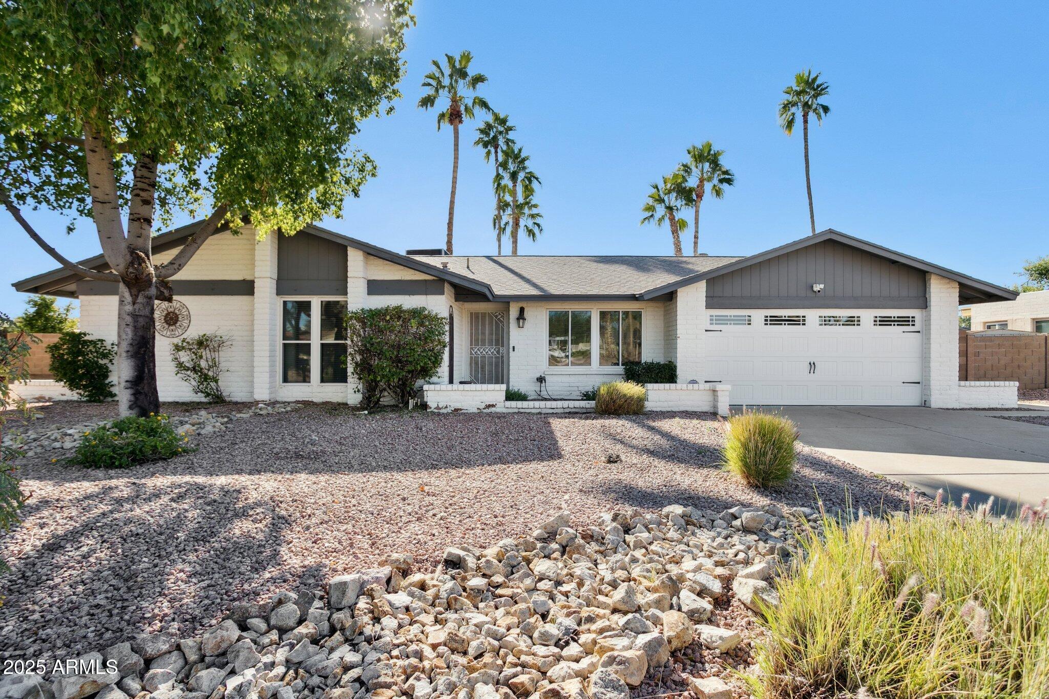 4915 East Everett Drive Scottsdale, AZ 85254 - Photo 31 of 39 a front view of a house with garden
