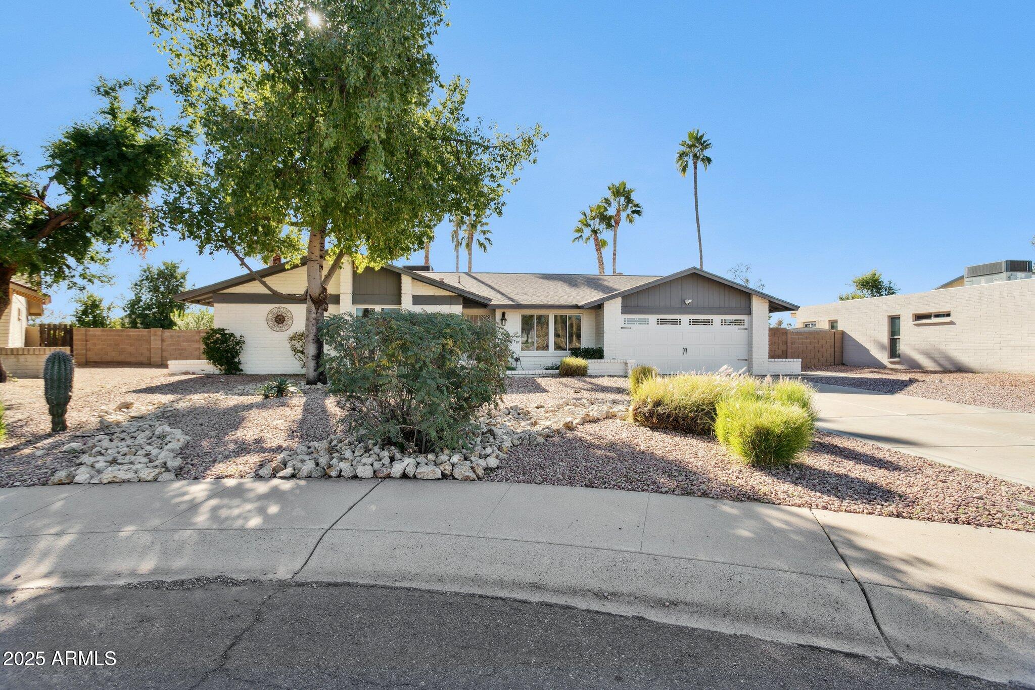 4915 East Everett Drive Scottsdale, AZ 85254 - Photo 32 of 39 a front view of a house with garden