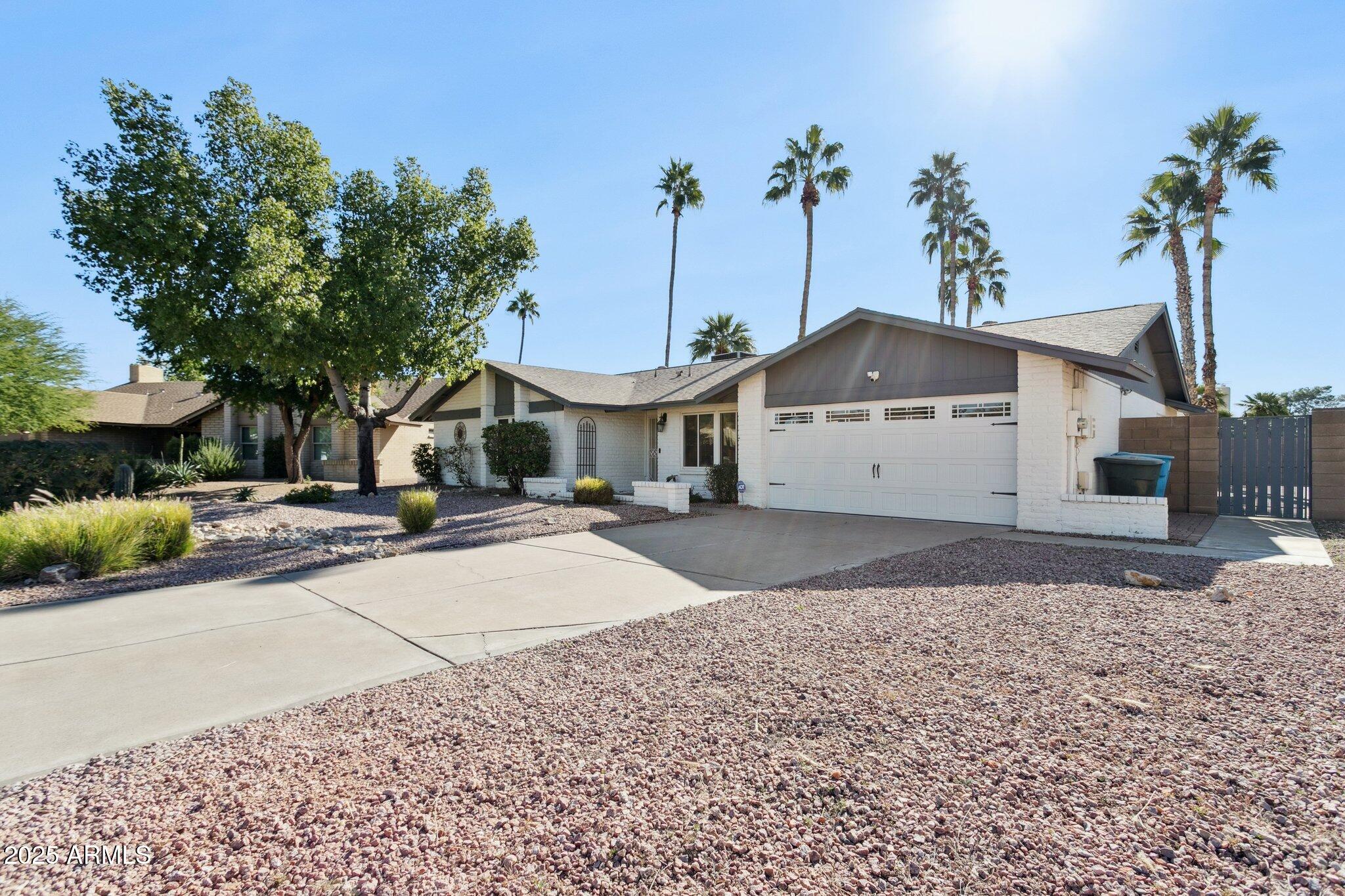 4915 East Everett Drive Scottsdale, AZ 85254 - Photo 34 of 39 a front view of a house with a yard and garage