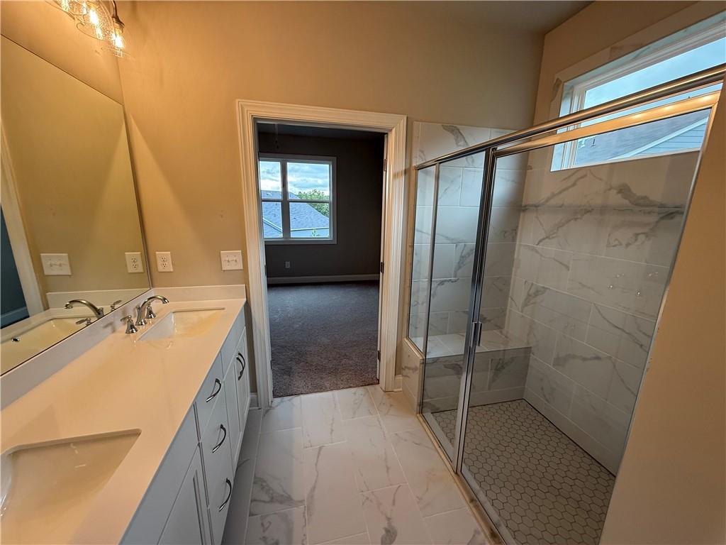 329 Lakeside Drive Canton, GA 30114 - Photo 11 of 34 a bathroom with a tub sink and mirror