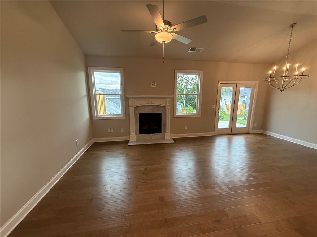 329 Lakeside Drive Canton, GA 30114 - Photo 7 of 34 an empty room with wooden floor fireplace and windows