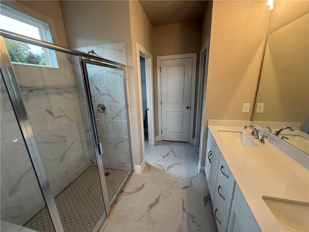329 Lakeside Drive Canton, GA 30114 - Photo 10 of 34 a bathroom with a sink a mirror and shower