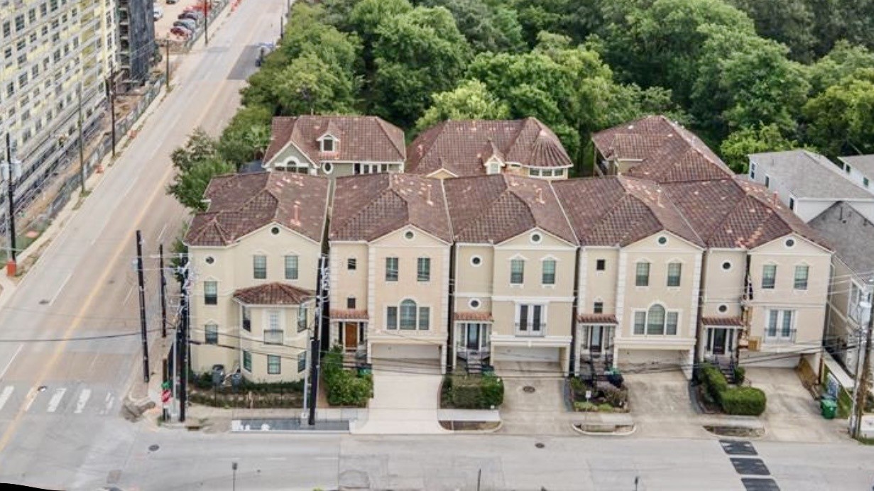 a front view of multiple houses with yard
