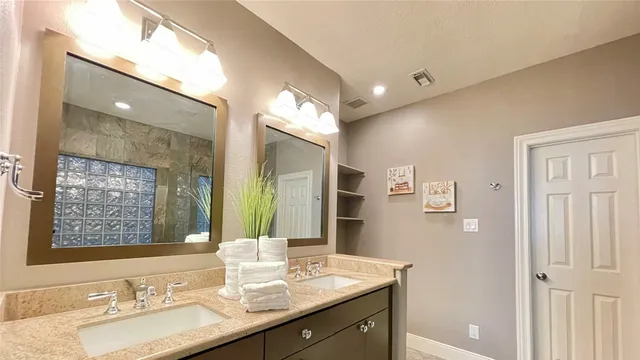 a bathroom with a granite countertop sink mirror and double