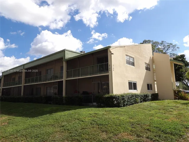 a view of a back yard with a wooden fence