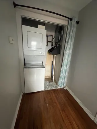 a view of empty room with wooden floor and cabinet