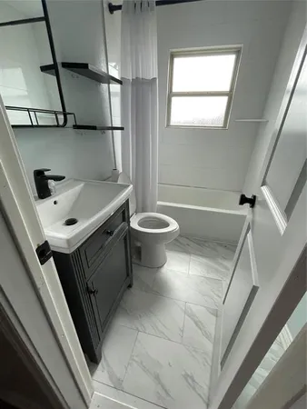 a bathroom with a sink a toilet and a bathtub