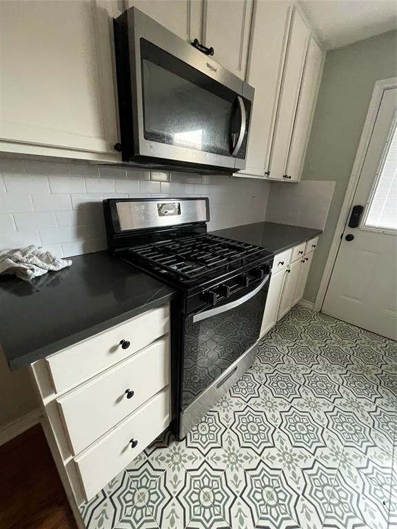2517 Amelia Street Dallas, TX 75235 - Photo 6 of 7 a kitchen with stainless steel appliances a stove and a microwave