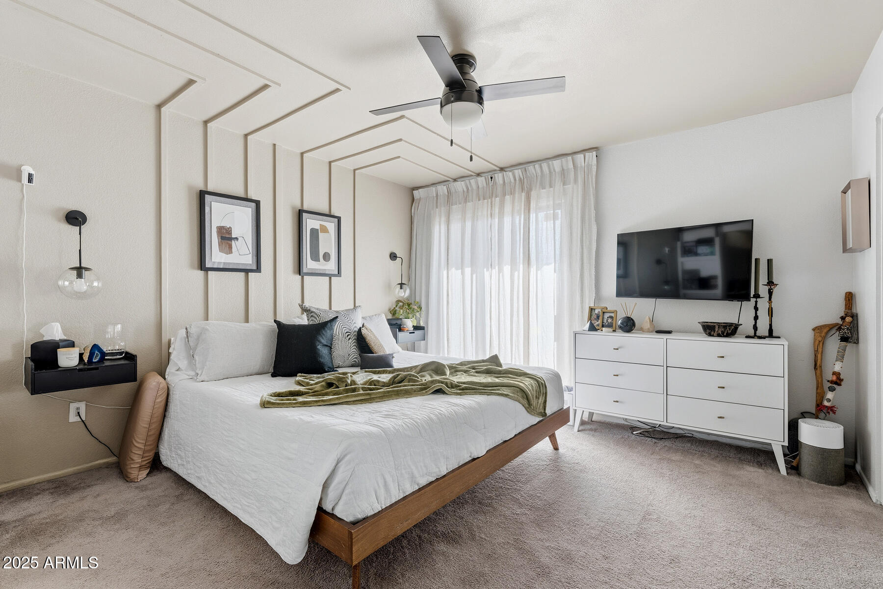 835 North Granite Reef Road, Unit 12 Scottsdale, AZ 85257 - Photo 12 of 23 a bedroom with a bed flat screen tv and dresser