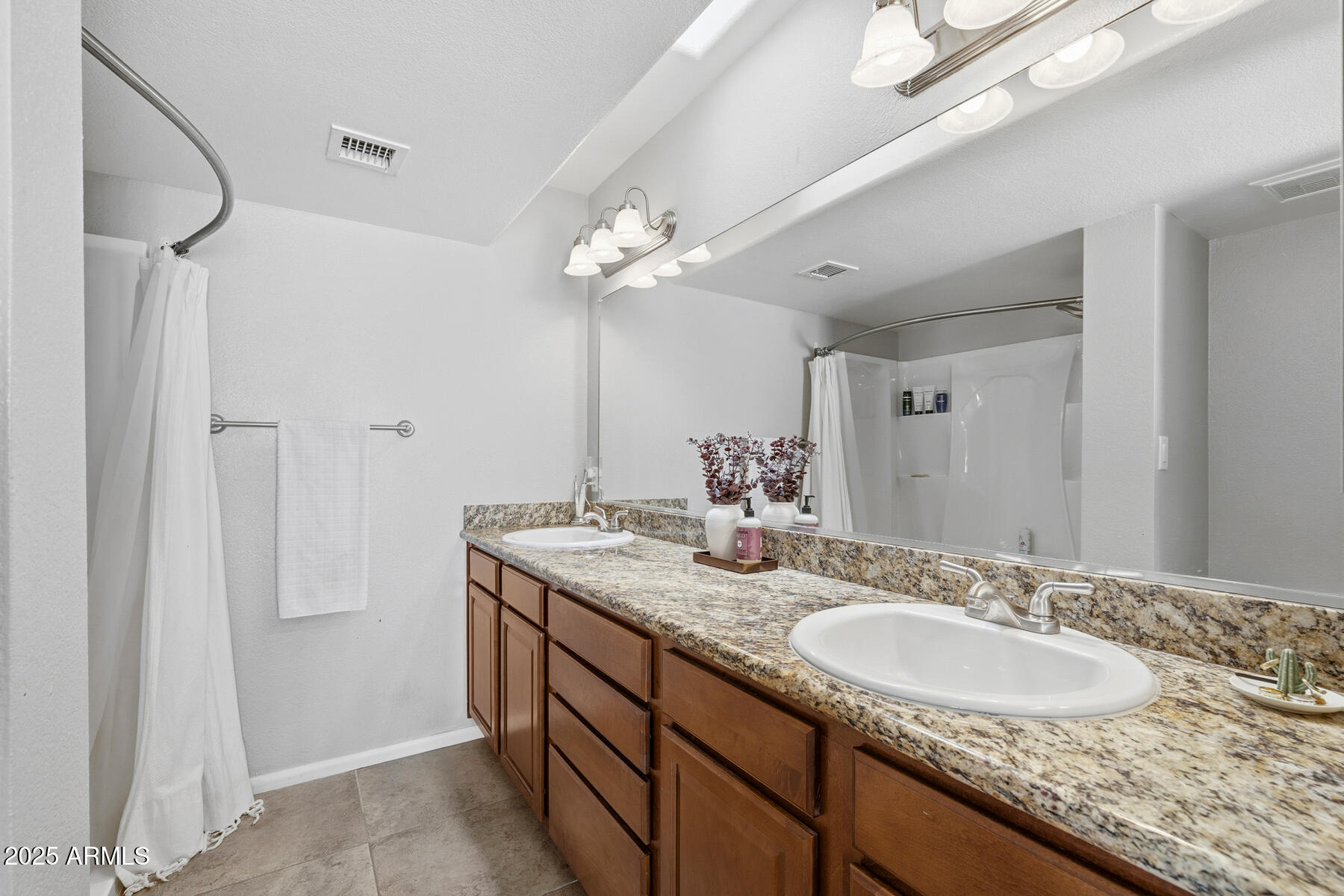 835 North Granite Reef Road, Unit 12 Scottsdale, AZ 85257 - Photo 15 of 23 a bathroom with a granite countertop sink and a mirror