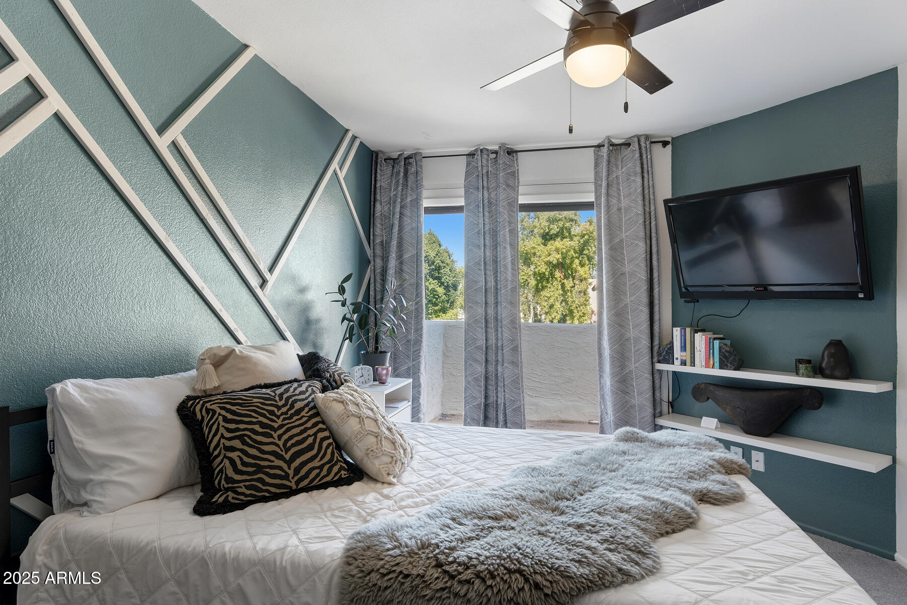 835 North Granite Reef Road, Unit 12 Scottsdale, AZ 85257 - Photo 16 of 23 a bedroom with a bed and a flat screen tv