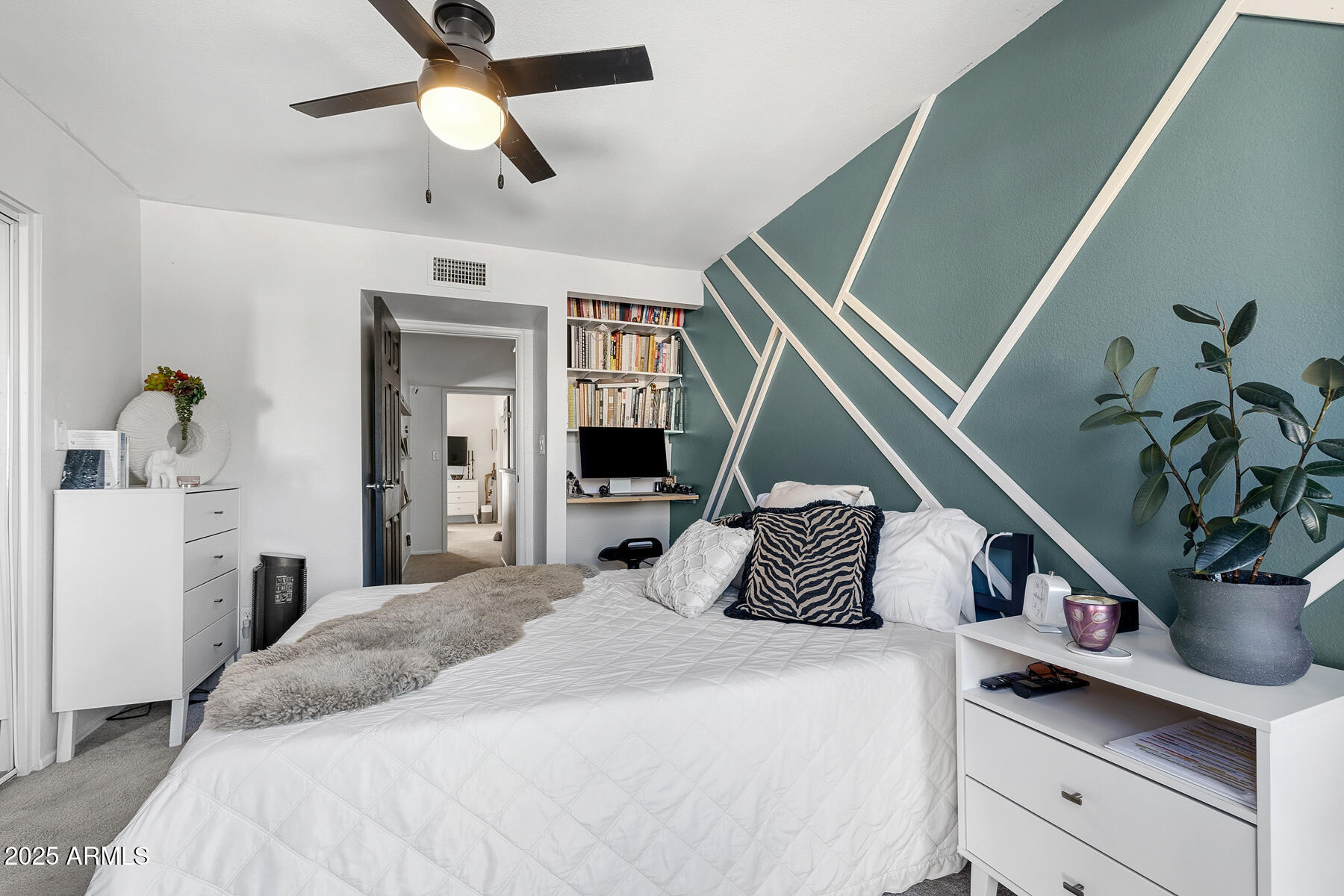835 North Granite Reef Road, Unit 12 Scottsdale, AZ 85257 - Photo 17 of 23 a bedroom with a large bed and a chandelier