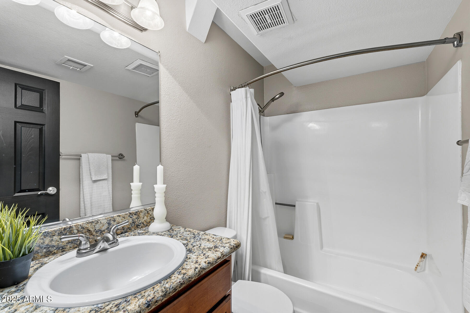 835 North Granite Reef Road, Unit 12 Scottsdale, AZ 85257 - Photo 18 of 23 a bathroom with a granite countertop sink toilet and shower