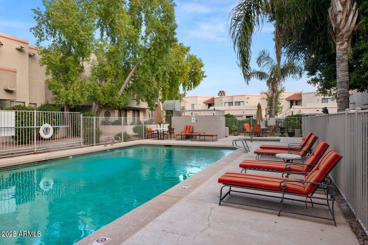 835 North Granite Reef Road, Unit 12 Scottsdale, AZ 85257 - Photo 4 of 23 a swimming pool with outdoor seating and yard