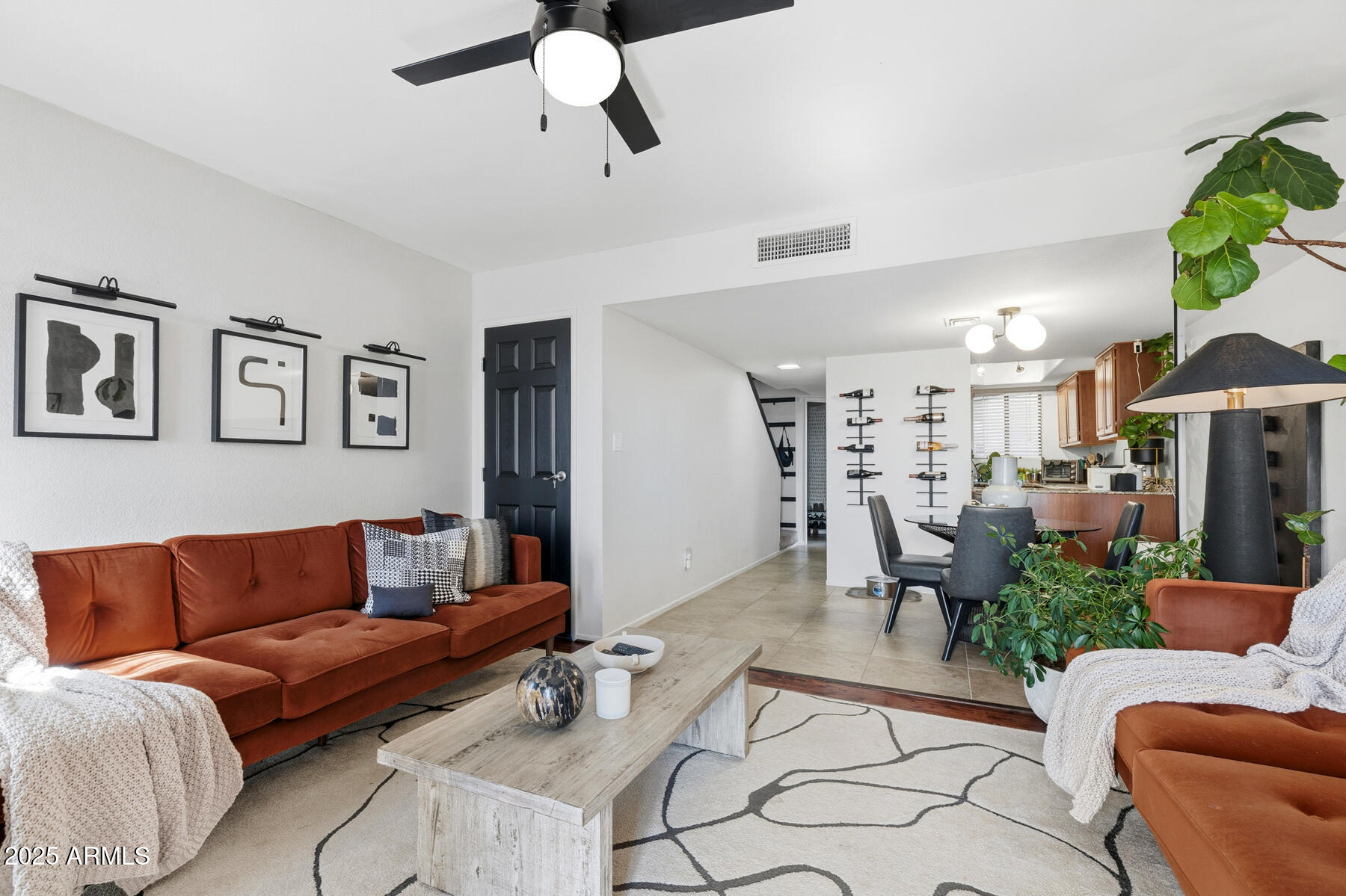835 North Granite Reef Road, Unit 12 Scottsdale, AZ 85257 - Photo 7 of 23 a living room with furniture kitchen view and a chandelier