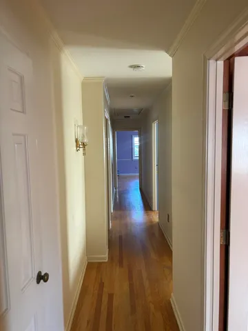 a view of a room with wooden floor and a window