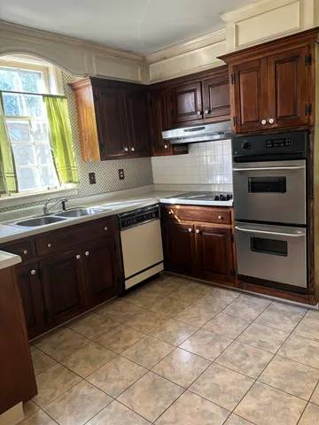 a bathroom with a toilet a sink and a mirror