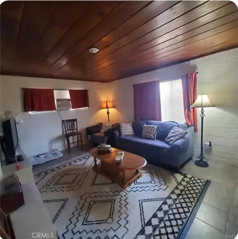 a living room with furniture a rug and a chandelier