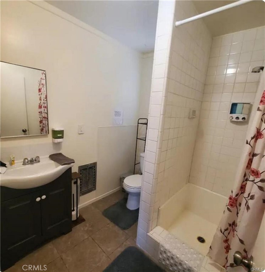 15521 4th Street Victorville, CA 92395 - Photo 25 of 27 a bathroom with a sink a toilet and shower