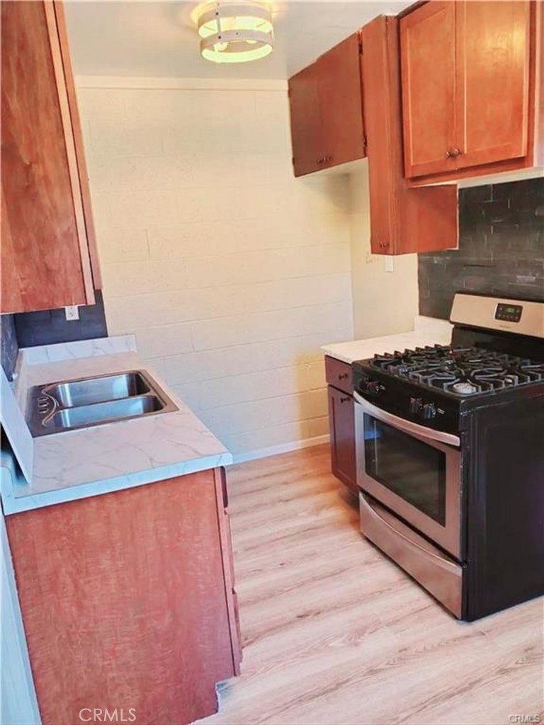 15521 4th Street Victorville, CA 92395 - Photo 8 of 27 a kitchen with a stove and a microwave