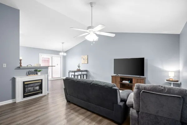 a living room with furniture a fireplace and a flat screen tv