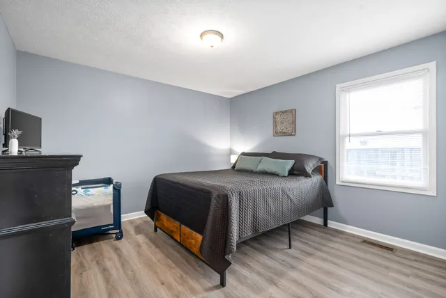 a bedroom with a bed and a window