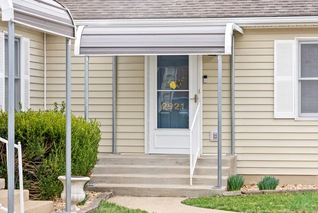 a front view of a house with plants