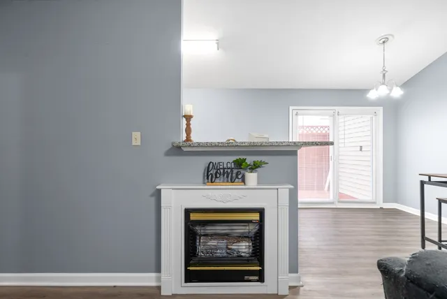 a hallway with a fireplace and wooden floor
