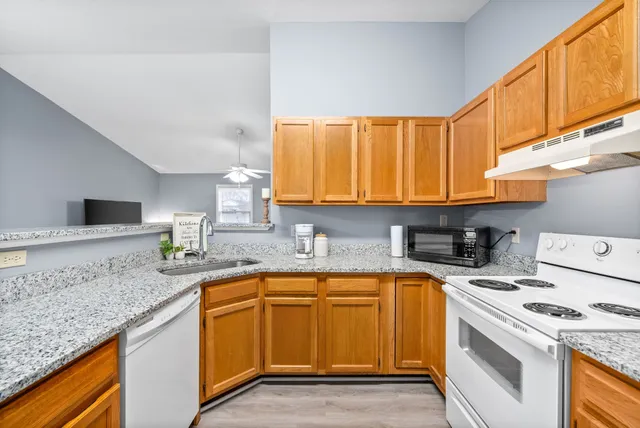 a kitchen with a sink a stove and cabinets