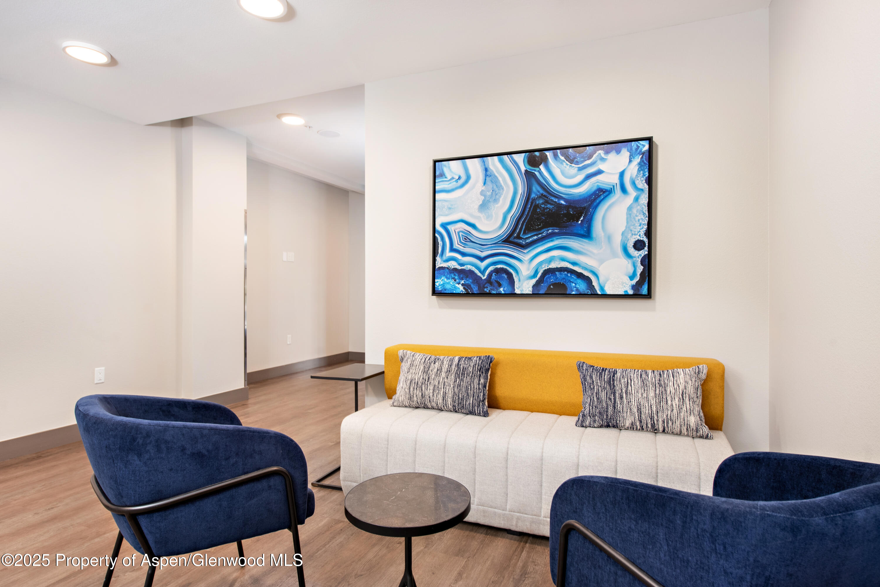 253 Wulfsohn Road, Unit 301 Glenwood Springs, CO 81601 - Photo 14 of 45 a living room with a couch and paintings on the wall
