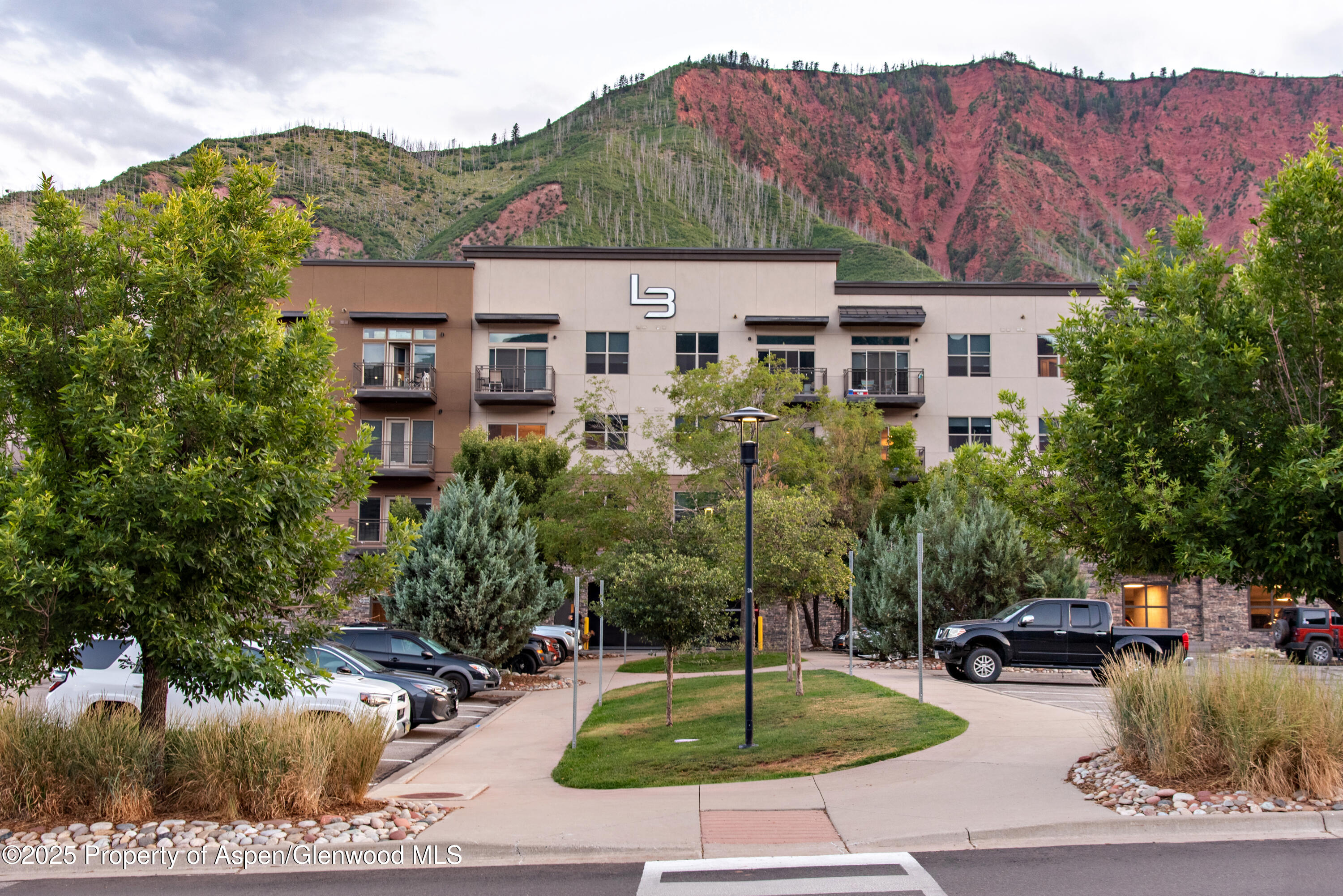 253 Wulfsohn Road, Unit 301 Glenwood Springs, CO 81601 - Photo 37 of 45 a front view of a house with a garden and yard
