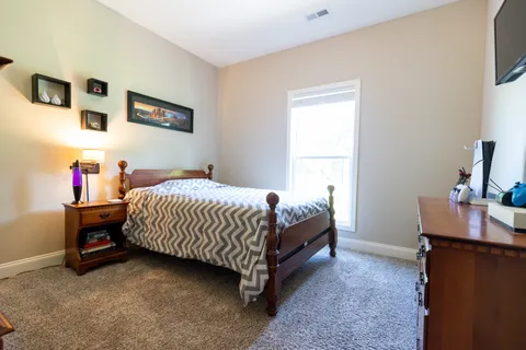 a bedroom with a bed and a desk