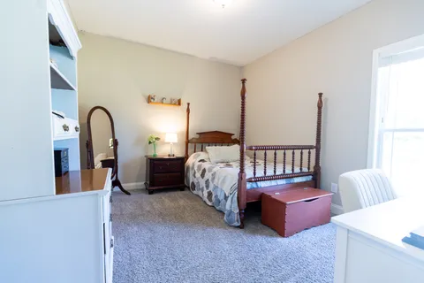 a bedroom with bed and a window