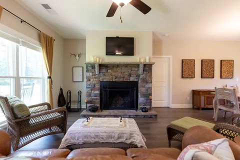 a living room with furniture flat screen tv and a fireplace