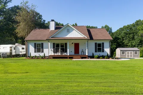 a front view of a house with swimming pool having outdoor seating