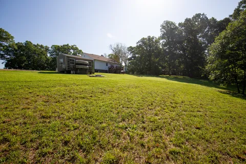 a view of a big yard with a large trees