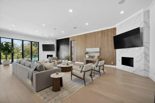 a living room with furniture a fireplace and a flat screen tv