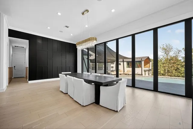 a living room with furniture and large windows