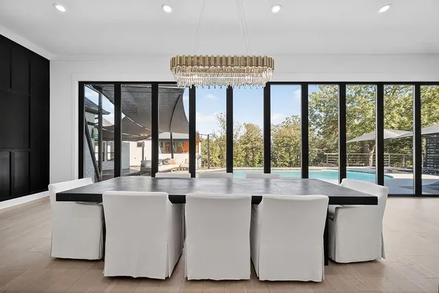 a dining table sitting next to a large window
