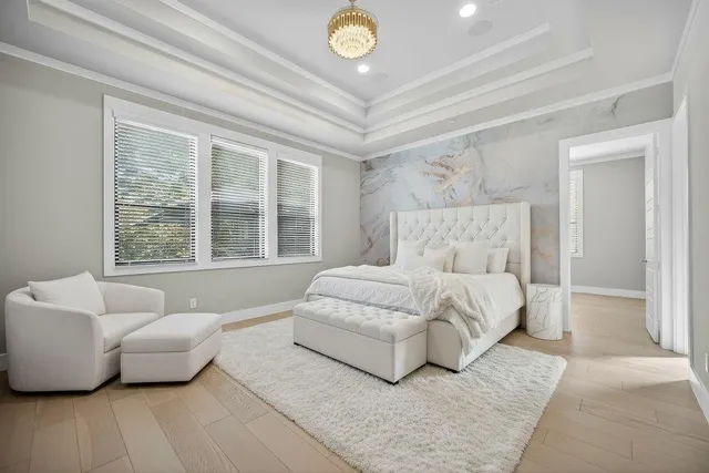 a spacious bedroom with a bed and a couch