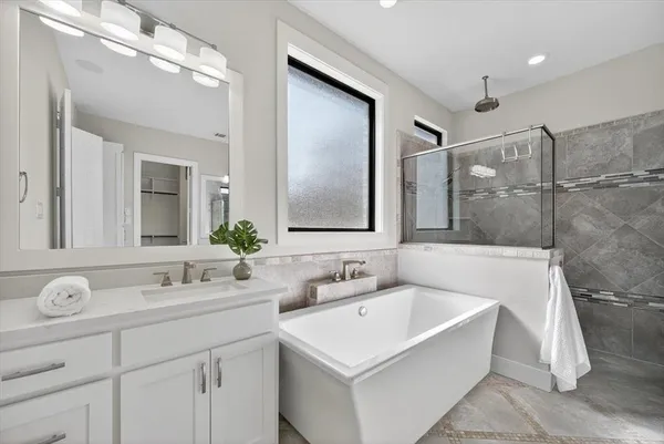 a bathroom with a bathtub and a sink