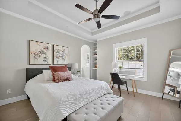 a bedroom with a large bed and a window