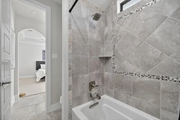 a bathroom with a tub and shower
