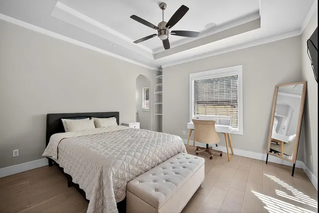 a bedroom with a bed and a large window