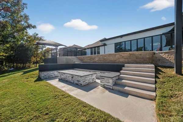 a view of a house with swimming pool and sitting area