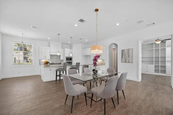 a view of a dining room with furniture and wooden floor