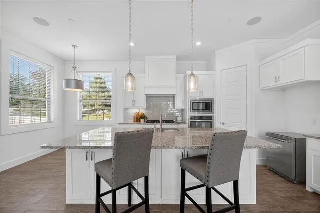 a dining room with furniture a window and kitchen view