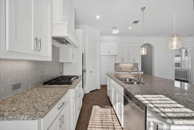 a kitchen with a stove and a white cabinets