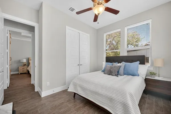 a bedroom with a large bed and a chandelier
